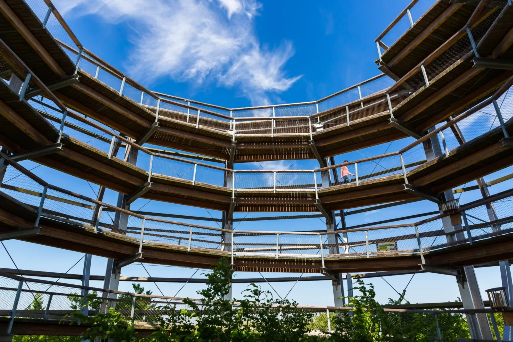 Urlaub mit Hund in Prora auf Rügen – Der perfekte Guide 10 Spiralförmiger Aussichtsturm aus Holz und Metall bei Prora auf Rügen, Blick nach oben zum blauen Himmel mit Wolken