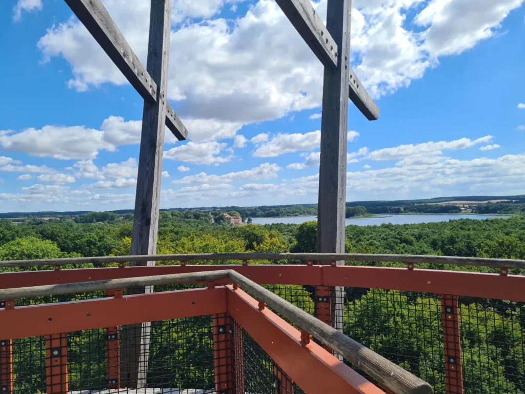 Panorama mit Eichen in Ivenacker, Blick von Holzturm auf See, Wald, Dorf und blauen Himmel mit Wolken

